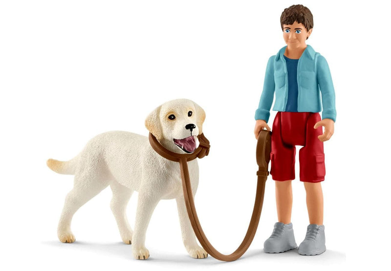 Man walking a Labrador Retriever Figurines